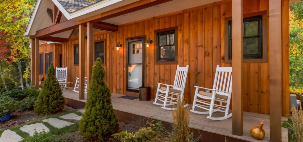 Wooden cabin porch with white rocking chairs at The Preserve Resort & Spa