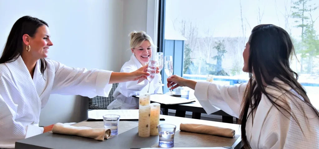 Women toasting champagne in spa robes at The Preserve Resort & Spa