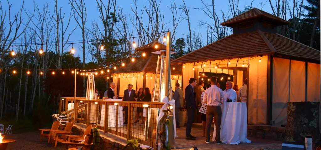 Guests enjoying an evening scotch and cigar safari event at The Preserve Resort & Spa, Rhode Island.