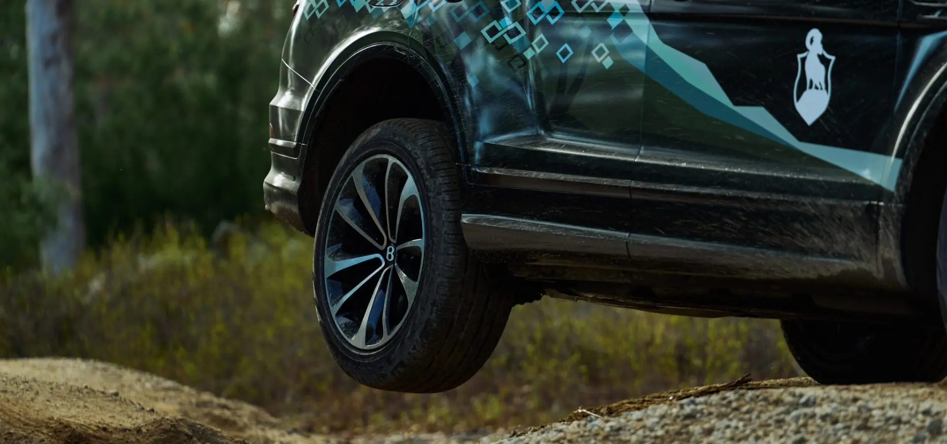 Close-up of Bentley Bentayga's wheel lifted off the ground during an off-road drive at The Preserve Sporting Club