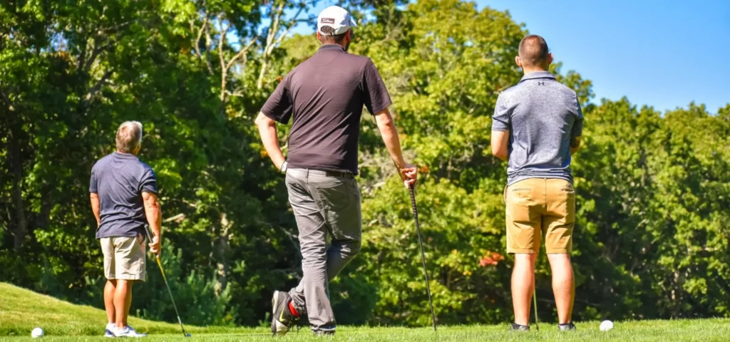 Three men playing golf at The Preserve Sporting Club.