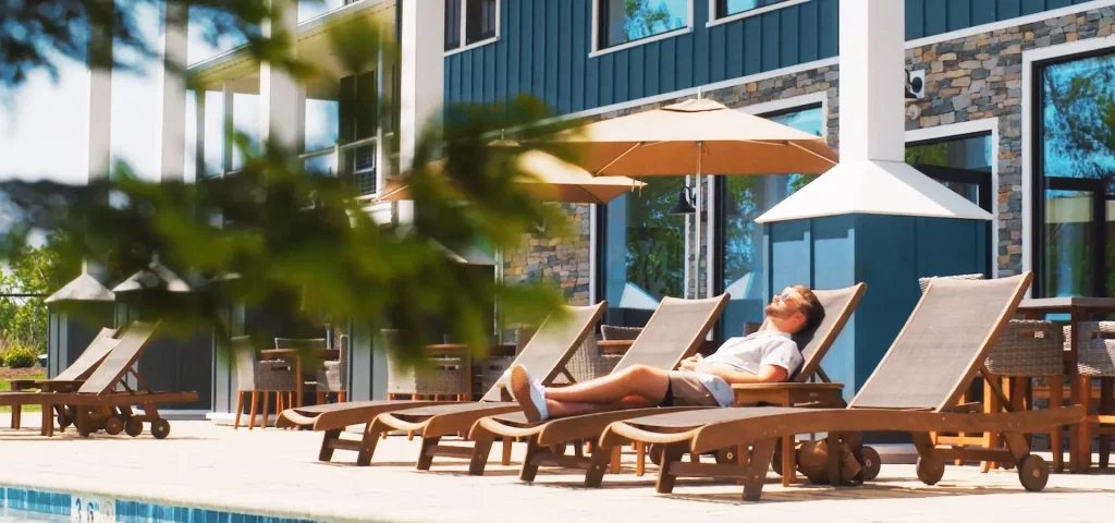 Guest relaxing by the pool at The Preserve Resort & Spa