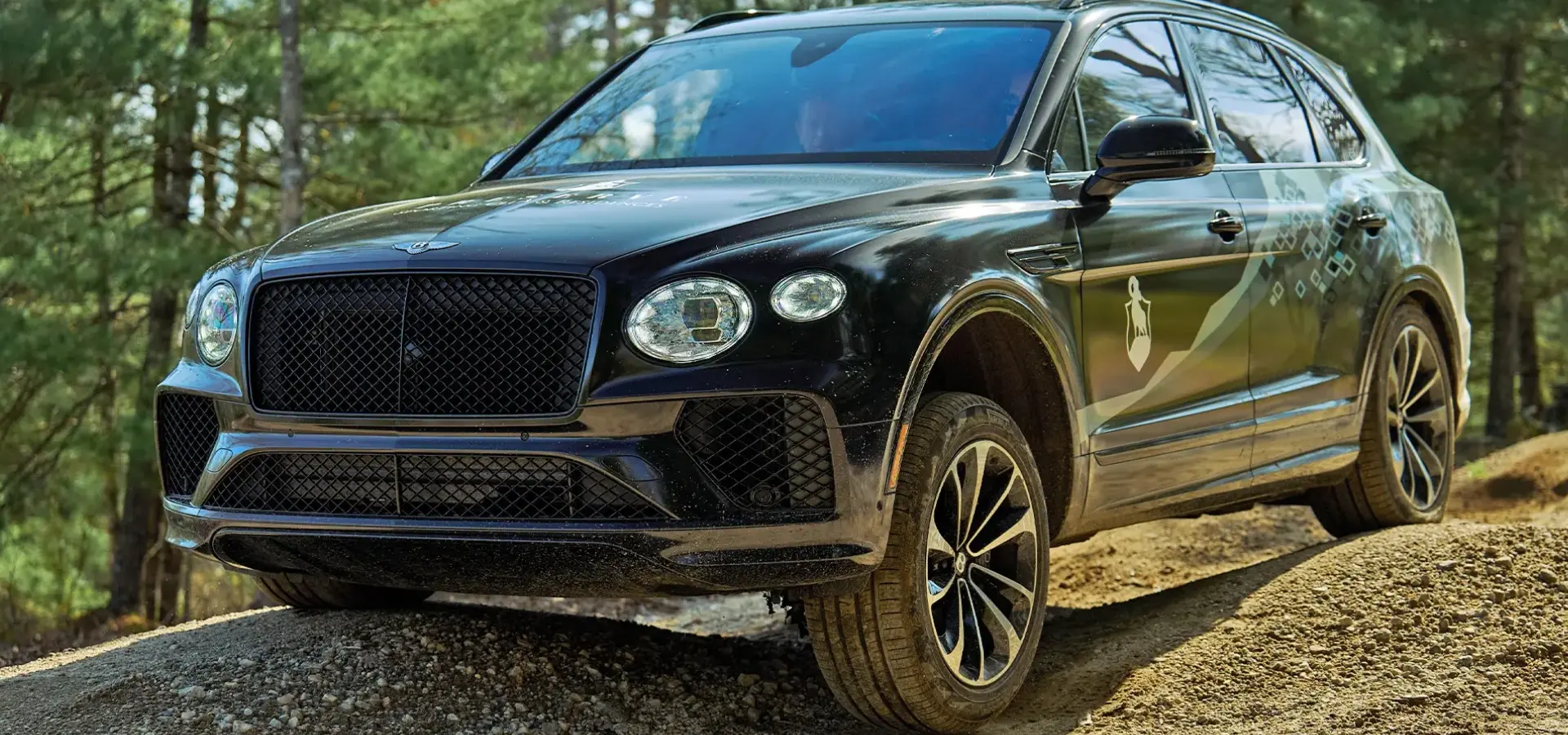 Bentley Bentayga driving on rugged terrain at The Preserve Resort & Spa.