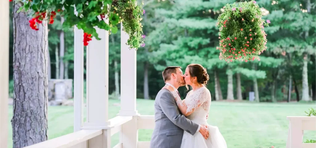 Couple sharing a kiss on a scenic porch at The Preserve Sporting Club & Resort.